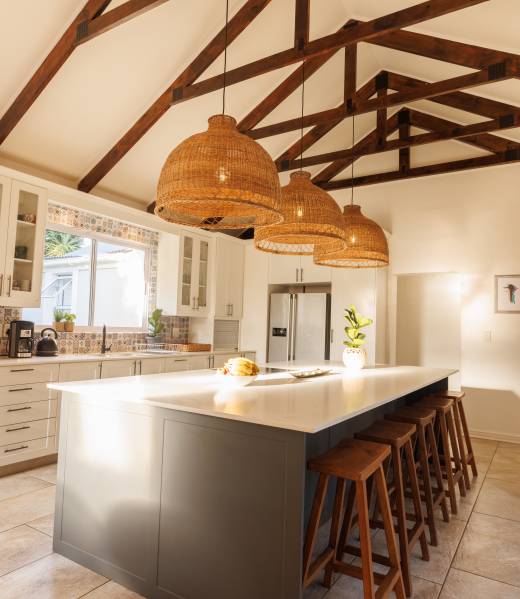 General view of modern kitchen with countertop, chairs and kitchen equipment. House interior and design concept. General view of modern kitchen with countertop, chairs and kitchen equipment. House interior and design concept.